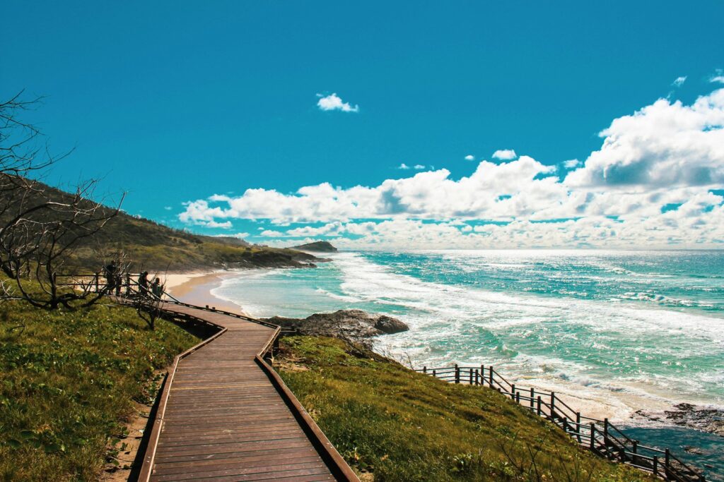 brown wooden pathway near sea under blue sky during daytime, Natural Wonders Of Australia